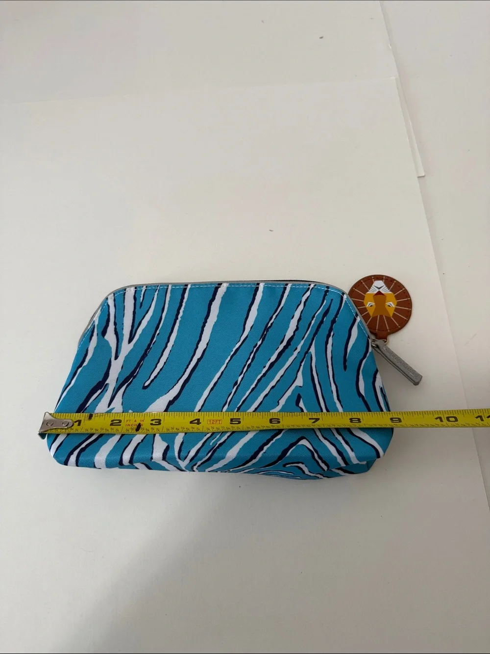 Estee Lauder Turquoise and White Zebra-Print Cosmetic Pouch with Lion Charm